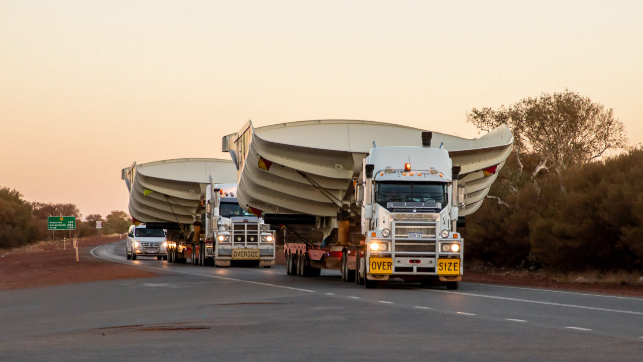 Two oversized loads hauling Hercules dump bodies