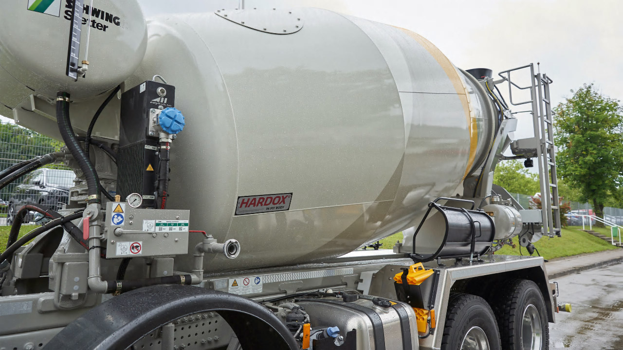 A white concrete mixer drum with the Hardox® In My Body logo.