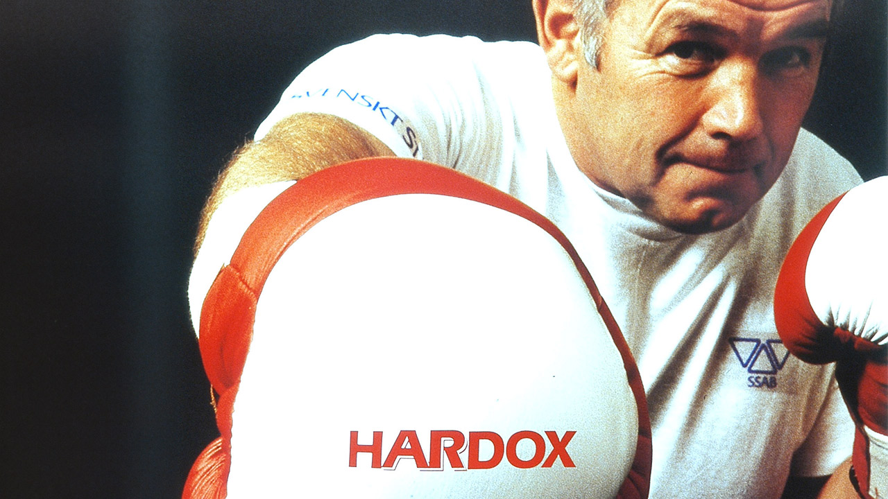 Closeup of a boxer with red and white gloves.