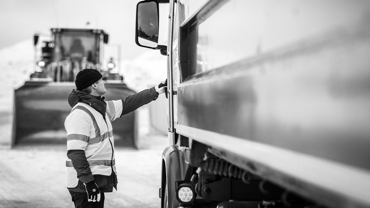 A truck driver about to get into the cab of a truck whose body is made in Hardox wear plate. 