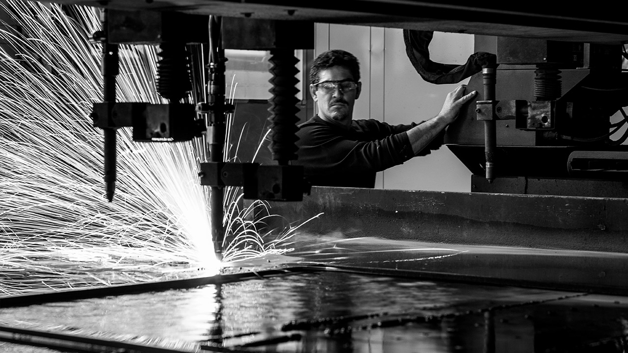 A man operating a cutting machine used to easily process Hardox wear plate.