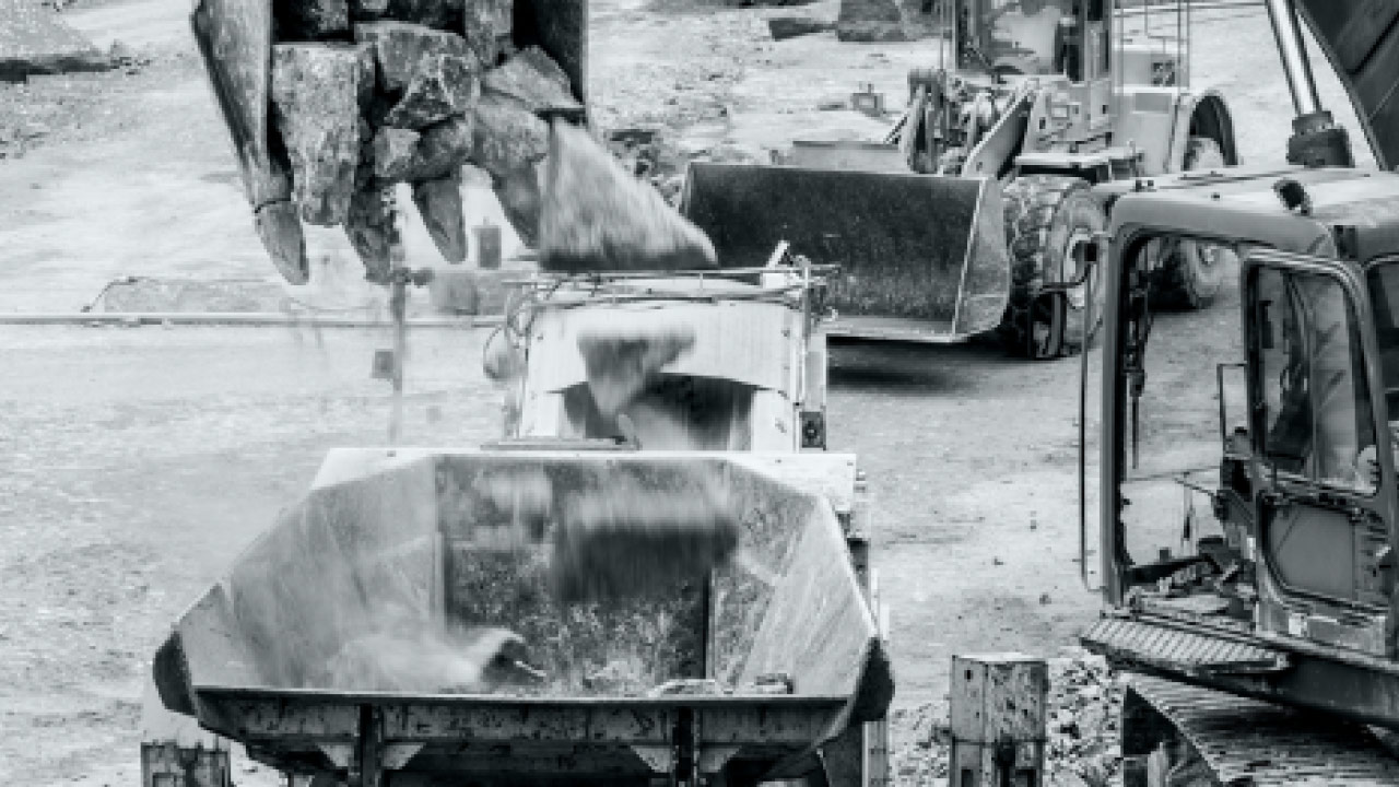 Rocks being dropped by a digging bucket into a crusher lined with Hardox 600 wear steel.