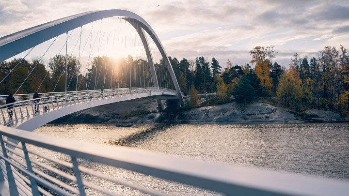 A bridge made in sustainable steel and a forest. High-strength steels can help lower carbon footprint.